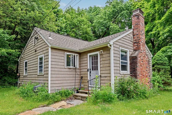 a aerial view of a house next to a yard