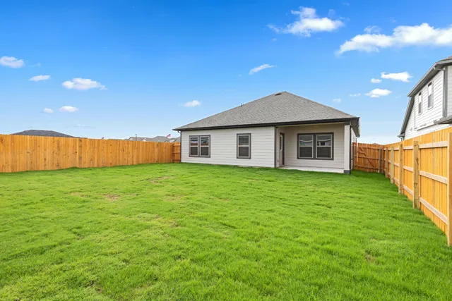 a view of a house with a backyard