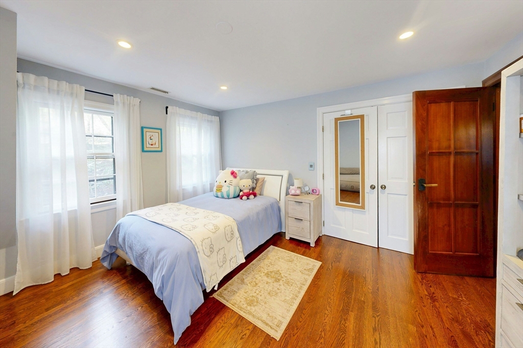 32 Alberta Road Brookline, MA 02467 - Photo 23 of 36 a bedroom with a bed and wooden floor