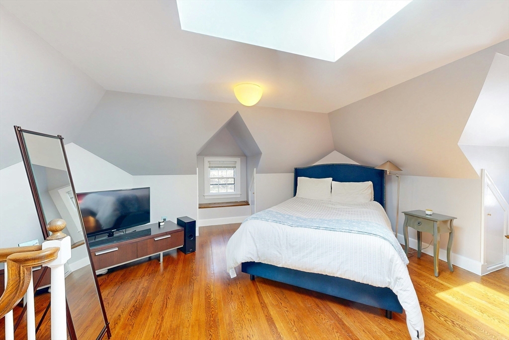 32 Alberta Road Brookline, MA 02467 - Photo 26 of 36 a bedroom with a bed and a flat screen tv