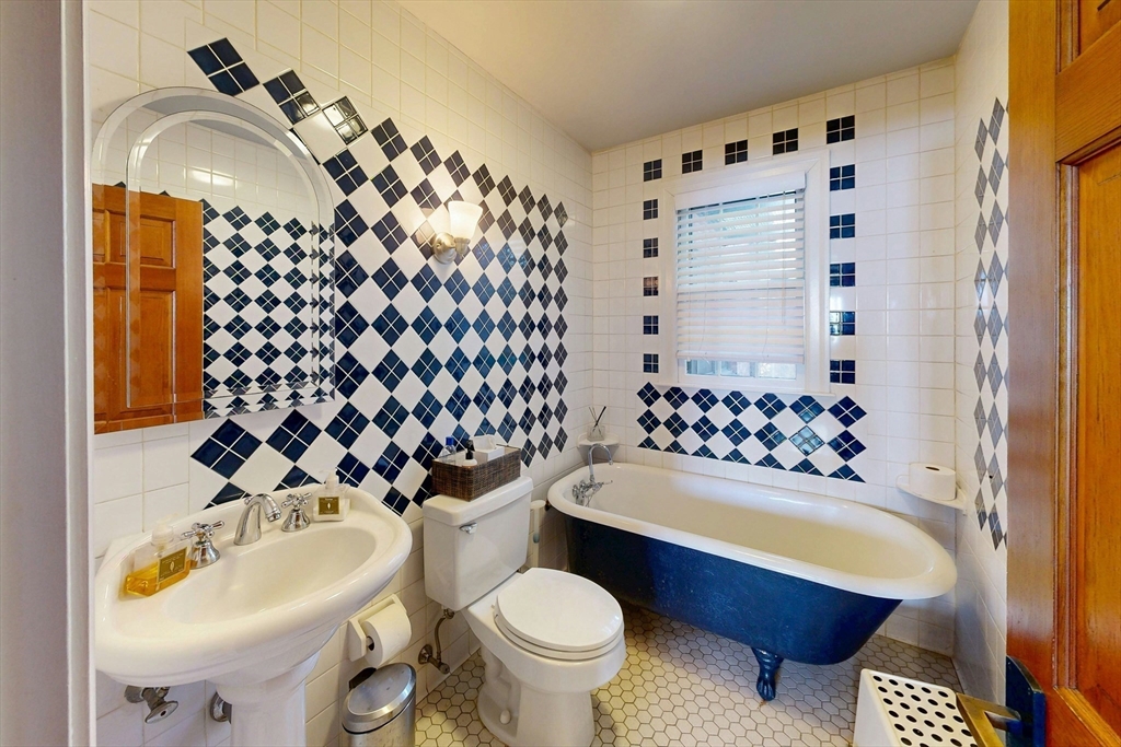 32 Alberta Road Brookline, MA 02467 - Photo 30 of 36 a bathroom with a sink toilet mirror and shower