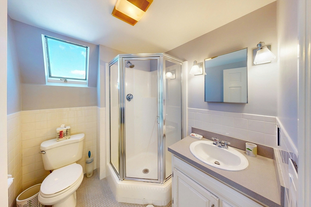 32 Alberta Road Brookline, MA 02467 - Photo 32 of 36 a bathroom with a granite countertop toilet sink and mirror