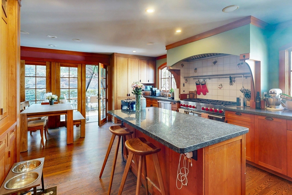 32 Alberta Road Brookline, MA 02467 - Photo 4 of 36 a kitchen with stainless steel appliances granite countertop a stove and a dining table