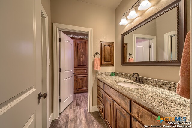 6197 Pfeil Road Schertz, TX 78154 - Photo 13 of 29 a bathroom with a granite countertop sink and a mirror