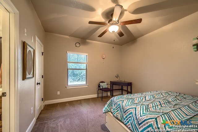 6197 Pfeil Road Schertz, TX 78154 - Photo 16 of 29 a bedroom with a bed and a chandelier