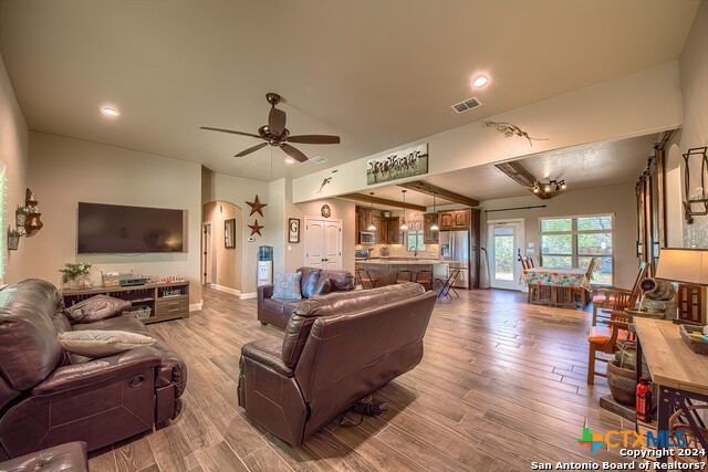 6197 Pfeil Road Schertz, TX 78154 - Photo 10 of 29 a living room with furniture a flat screen tv and a large window