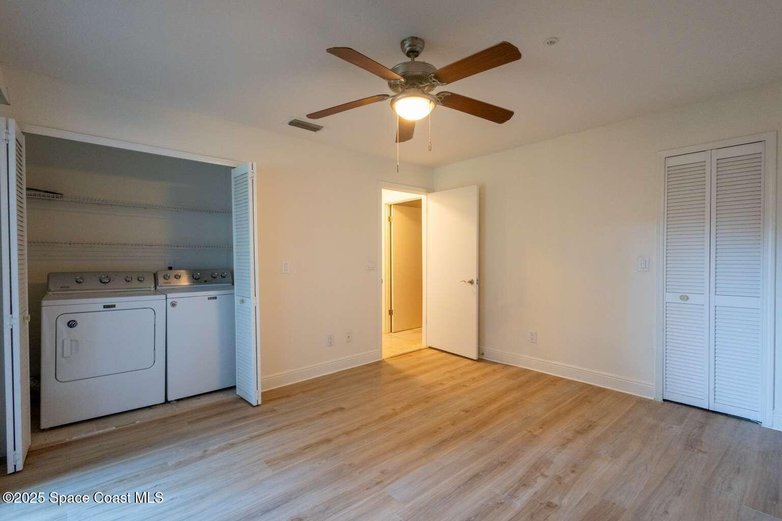 7667 North Wickham Road, Unit 822 Melbourne, FL 32940 - Photo 11 of 14 a view of an empty room with window and wooden floor