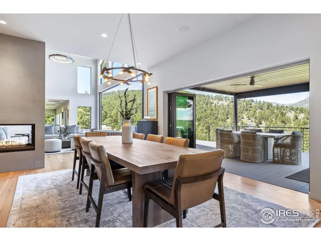 a dining room with furniture a chandelier and wooden floor