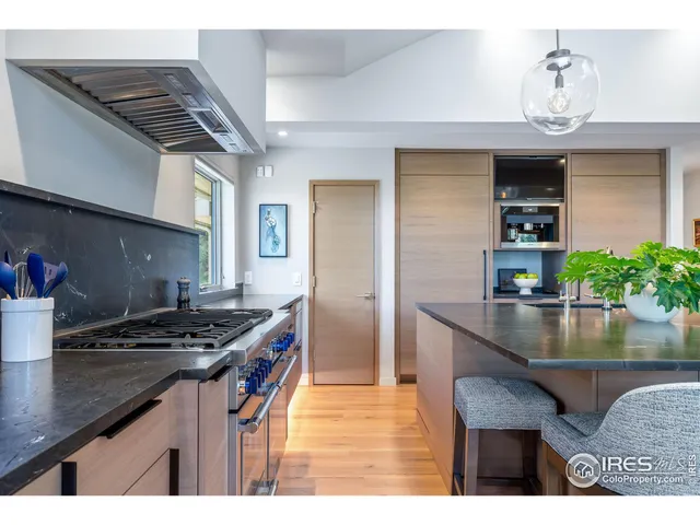 a kitchen with kitchen island stainless steel appliances a sink stove and refrigerator
