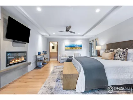 a bed room with a bed a television and a fireplace