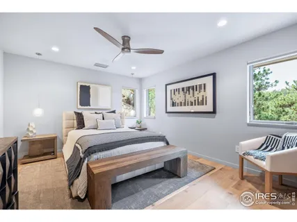 a bedroom with a bed and a painting on the wall