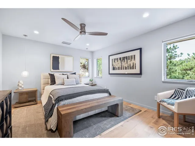 a bedroom with a bed and a painting on the wall