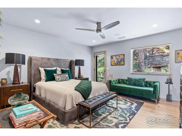 a living room with a bed and a rug