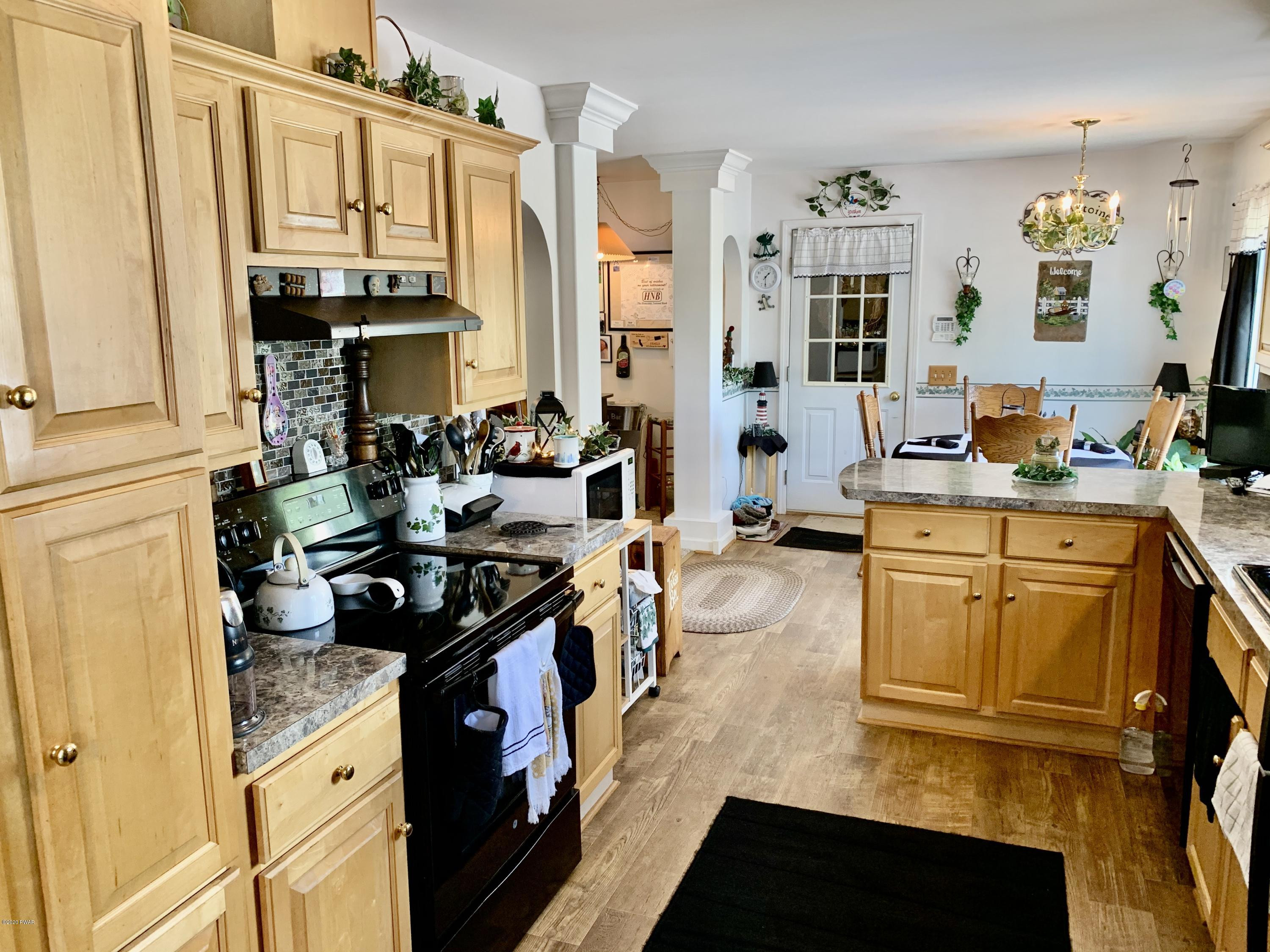 678 Stock Farm Road Lake Ariel, PA 18436 - Photo 8 of 41 a kitchen with stainless steel appliances a stove sink and cabinets