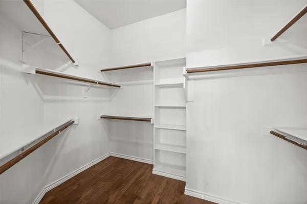 a view of walk in closet with empty racks