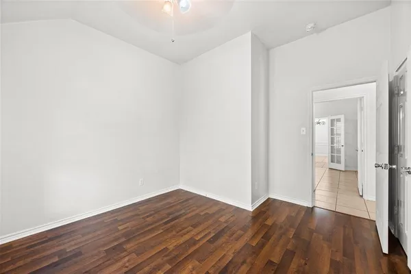 wooden floor in a hall with an empty room