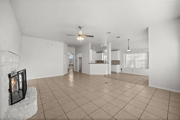 a view of a kitchen with furniture and refrigerator