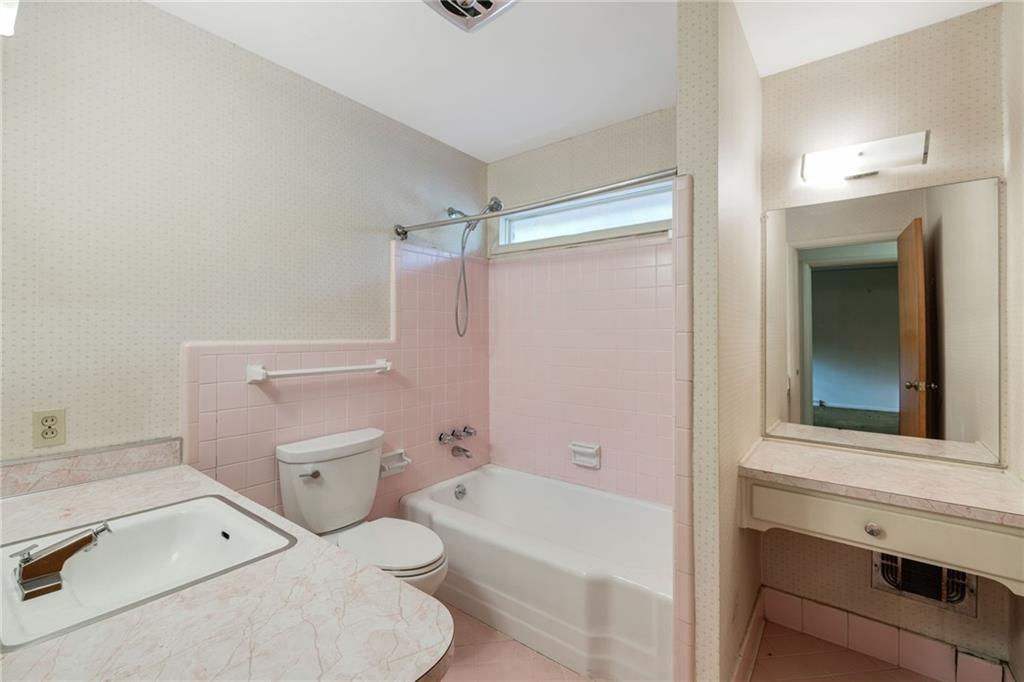 1911 Alderbrook Road Northeast Atlanta, GA 30345 - Photo 29 of 33 a bathroom with a sink a toilet and bathtub