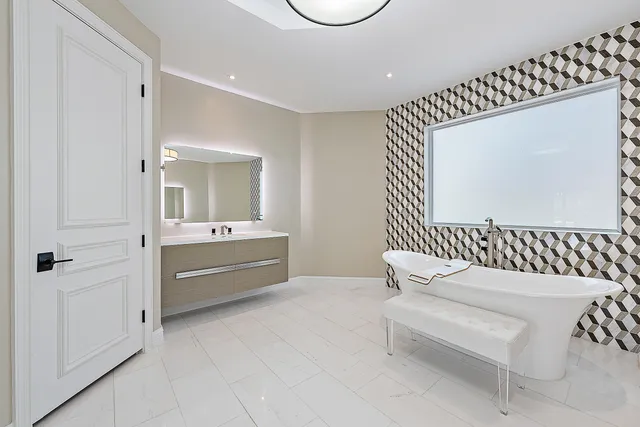 a bathroom with a sink a toilet and mirror