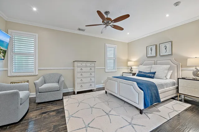 a spacious bedroom with a bed and ceiling fan