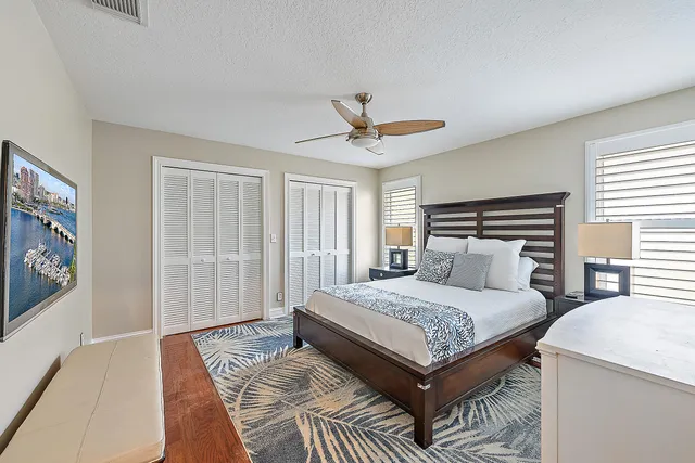 a bedroom with a large bed a rug and a window