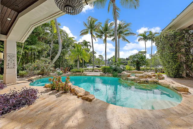a backyard of a house with barbeque oven table and chairs