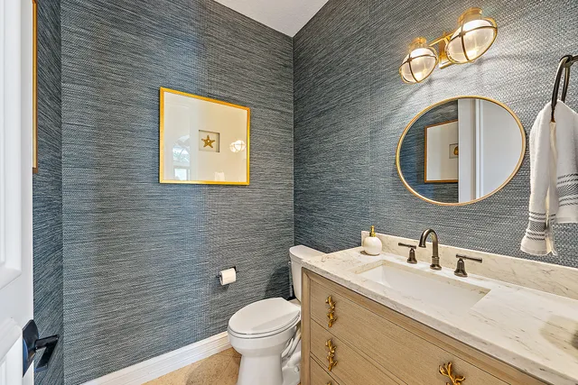 a bathroom with a toilet sink and mirror