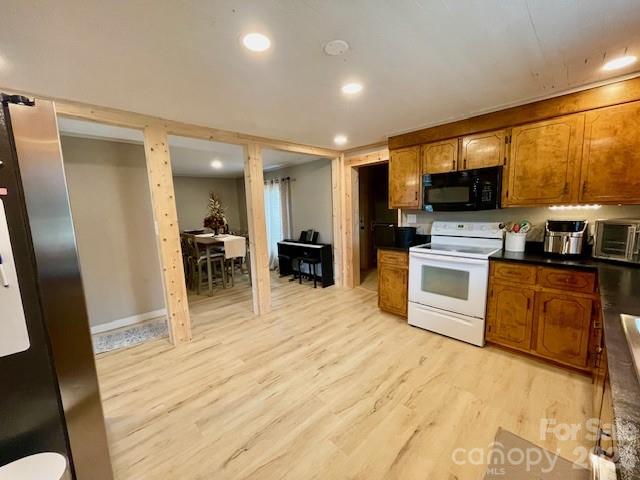 755 Depriest Road Bostic, NC 28018 - Photo 11 of 38 a kitchen with granite countertop a stove top oven a sink a dining table and chairs