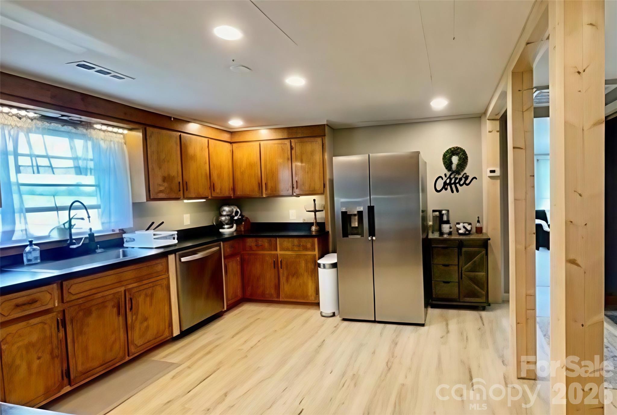755 Depriest Road Bostic, NC 28018 - Photo 12 of 38 a kitchen with stainless steel appliances granite countertop a refrigerator and a sink