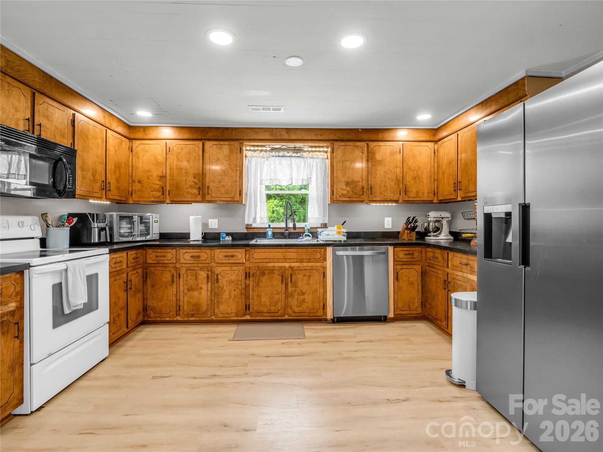 755 Depriest Road Bostic, NC 28018 - Photo 13 of 38 a kitchen with stainless steel appliances granite countertop a stove a sink and a refrigerator