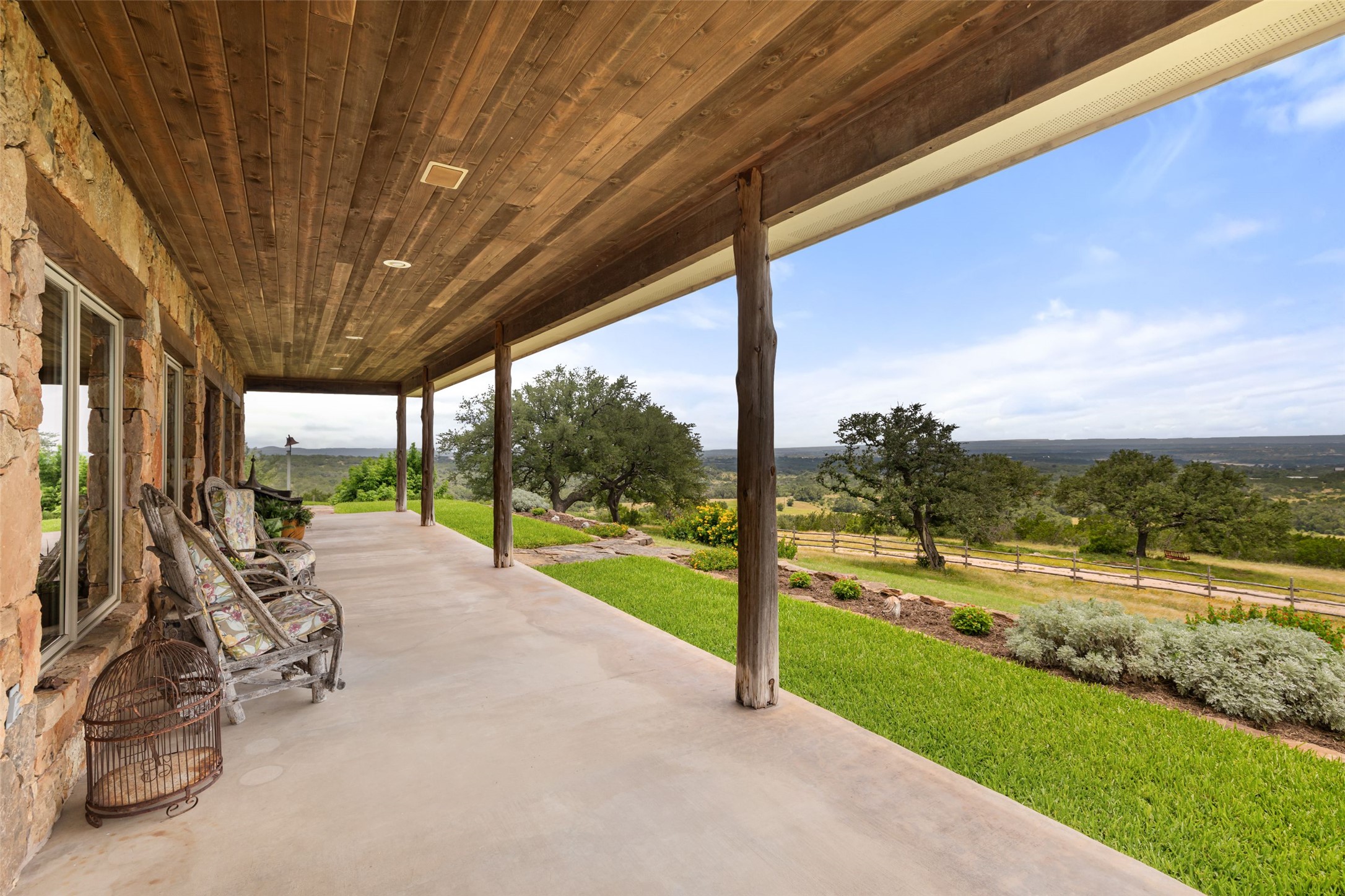 8400 Ranch Road 1431 Marble Falls, TX 78654 - Photo 5 of 30 Embrace tranquility with this expansive covered patio, offering panoramic views of the verdant landscape.