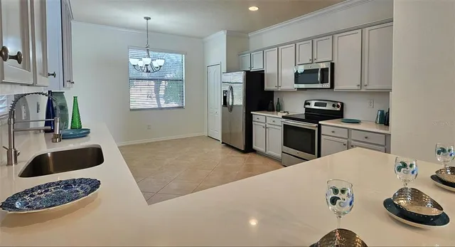 a kitchen with stainless steel appliances a stove a sink a microwave and cabinets