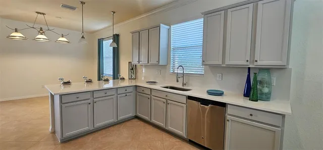a kitchen with a sink cabinets and window