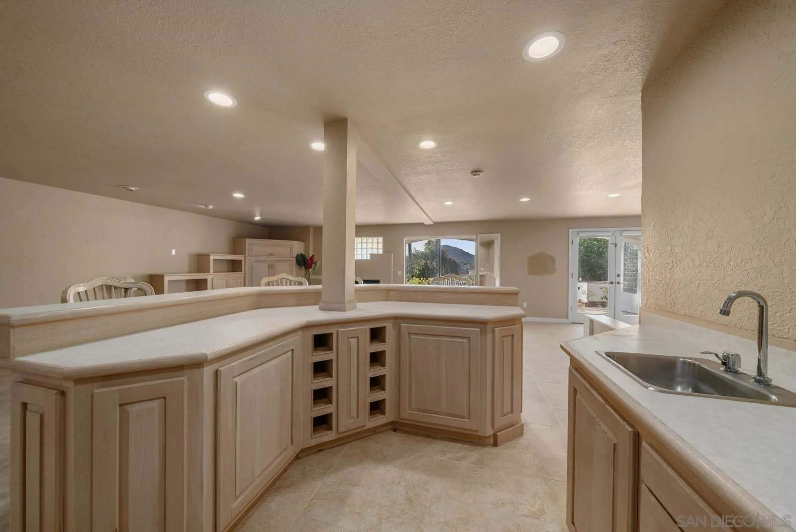 18695 Polvera Drive San Diego, CA 92128 - Photo 21 of 33 a kitchen with sink a stove and cabinets