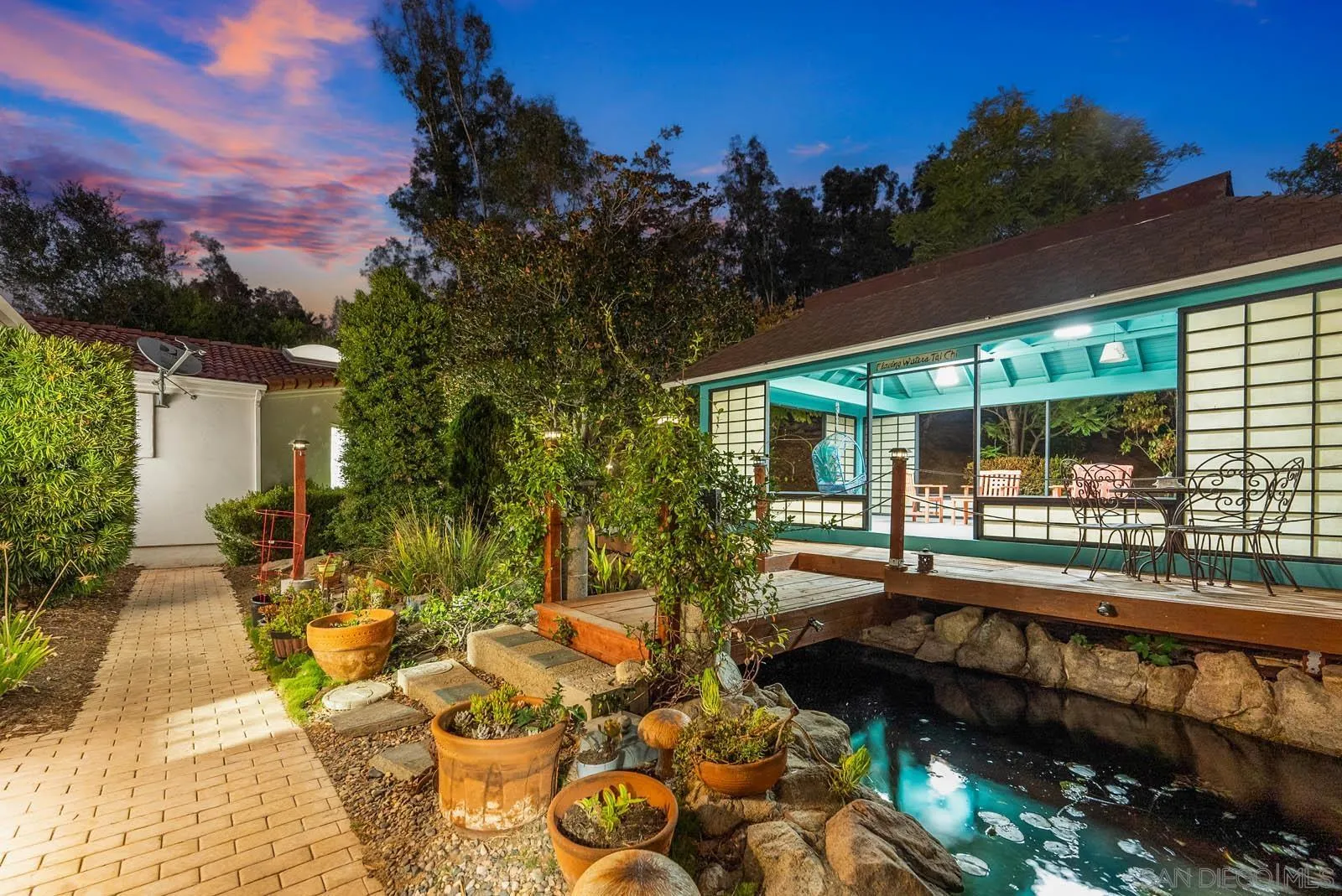 18695 Polvera Drive San Diego, CA 92128 - Photo 24 of 33 a view of a house with backyard sitting area and garden