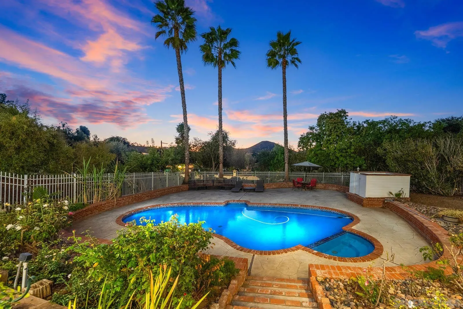 18695 Polvera Drive San Diego, CA 92128 - Photo 4 of 33 a view of a swimming pool with a table and chairs