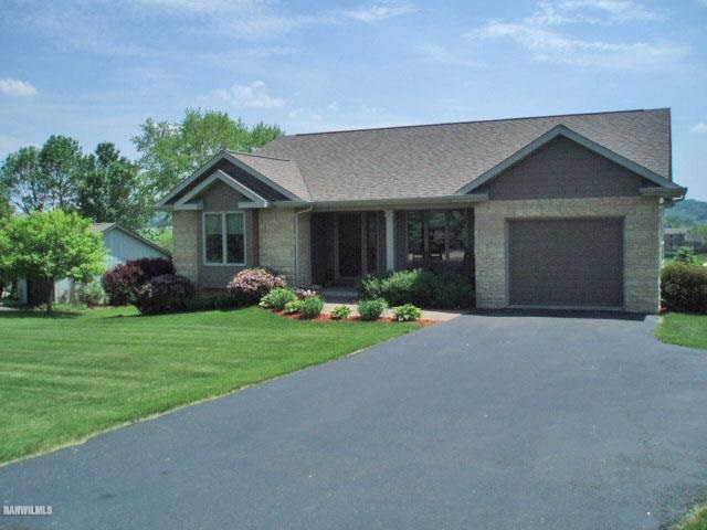 5 Beacon Trail Galena, IL 61036 - Photo 1 of 25 a front view of a house with garden