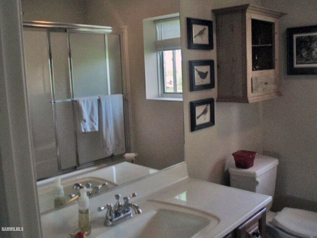 5 Beacon Trail Galena, IL 61036 - Photo 12 of 25 a bathroom with a sink toilet and mirror