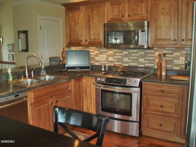 5 Beacon Trail Galena, IL 61036 - Photo 4 of 25 a kitchen with granite countertop a stove and a sink