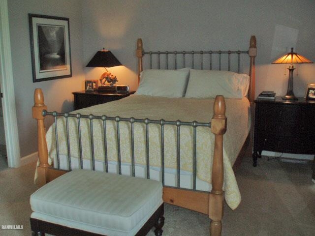 5 Beacon Trail Galena, IL 61036 - Photo 6 of 25 a bed sitting in a bedroom next to a lamp