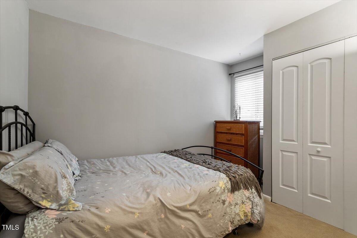 712 Godwin Court Raleigh, NC 27606 - Photo 18 of 27 a bedroom with a bed and a window