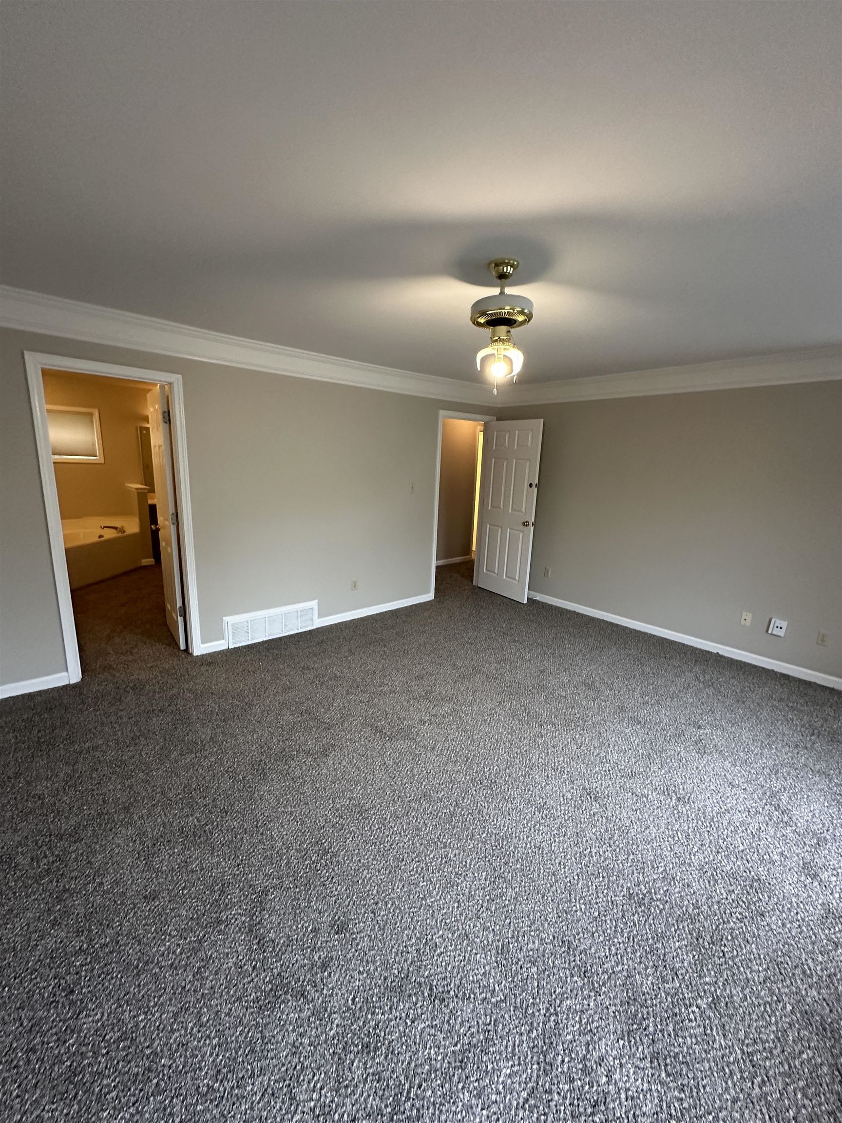 1959 Dartford Cove Memphis, TN 38016 - Photo 12 of 25 wooden floor in an empty room with a chandelier