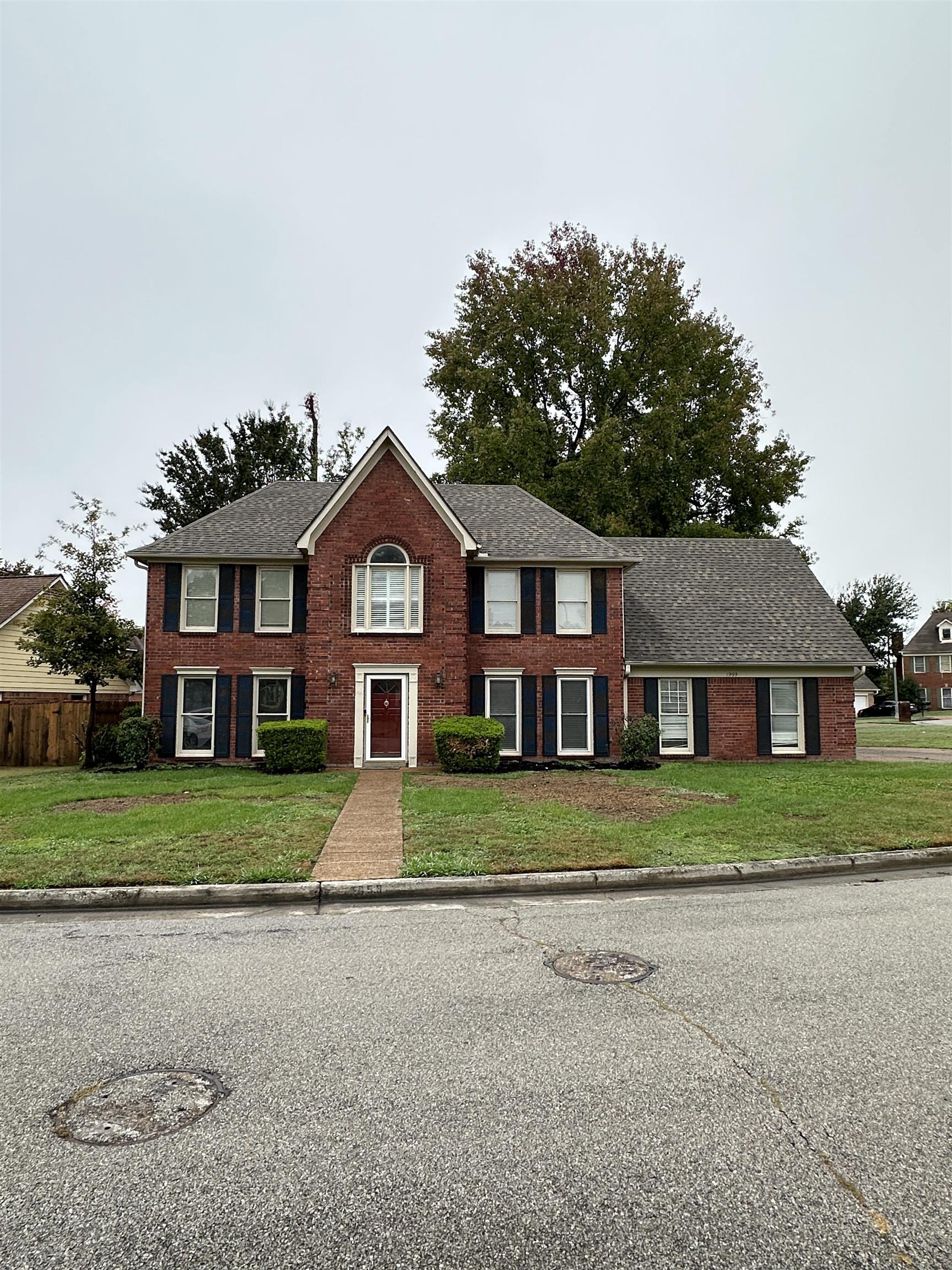 1959 Dartford Cove Memphis, TN 38016 - Photo 23 of 25 a front view of a house with a yard