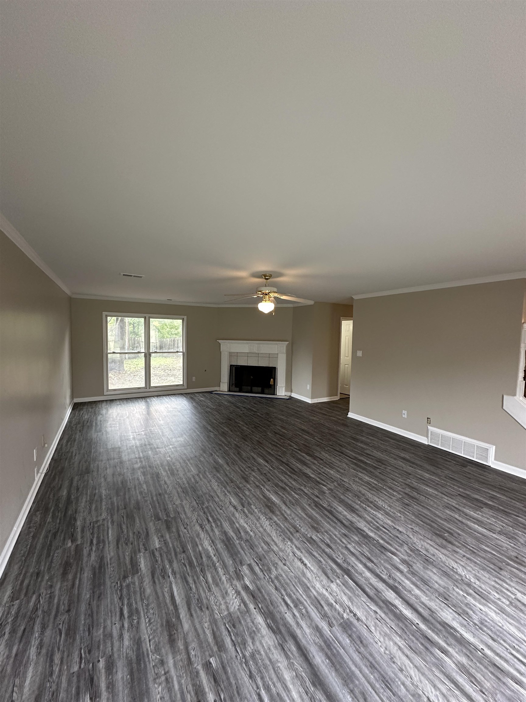 1959 Dartford Cove Memphis, TN 38016 - Photo 3 of 25 a view of empty room with wooden floor and fan