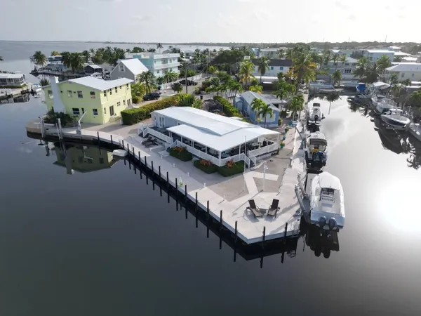 a view of a house with pool and chairs