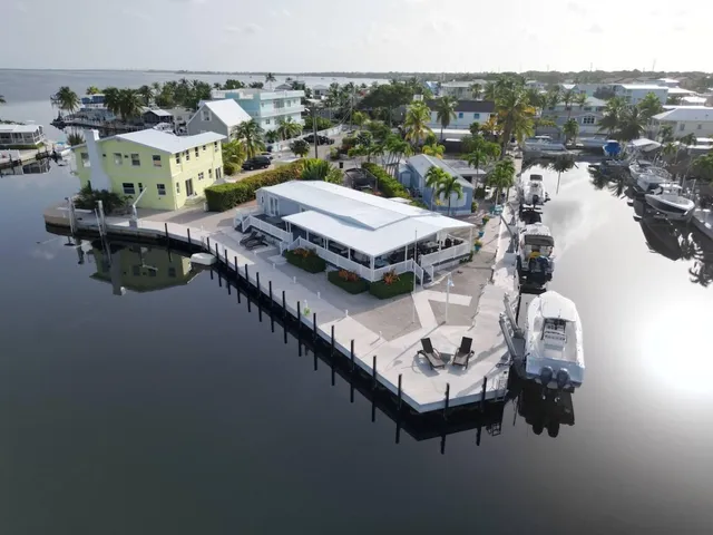 a view of a house with pool and chairs