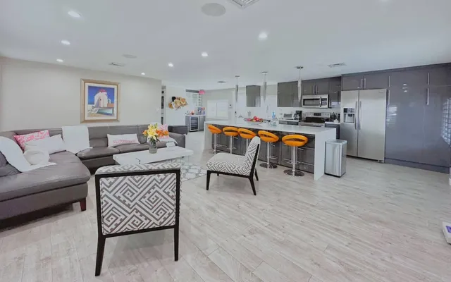 a living room with furniture and kitchen view