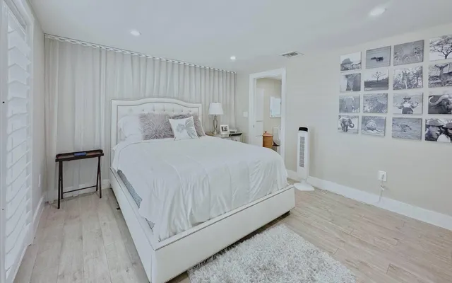 a bedroom with a bed and a night stand