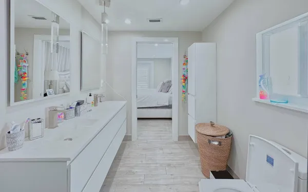a bathroom with a sink a toilet and shower