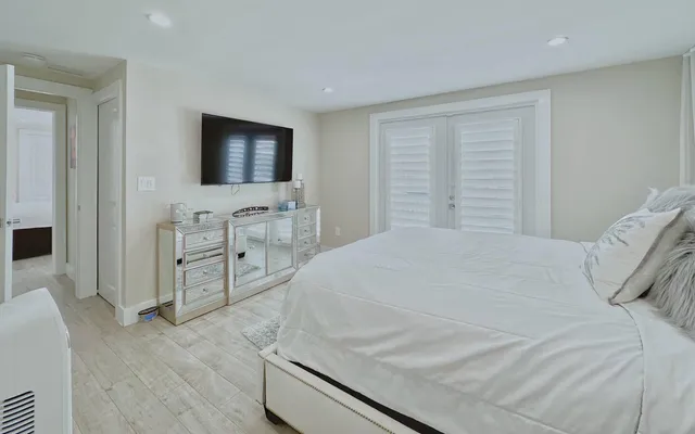 a bedroom with a bed and a flat screen tv